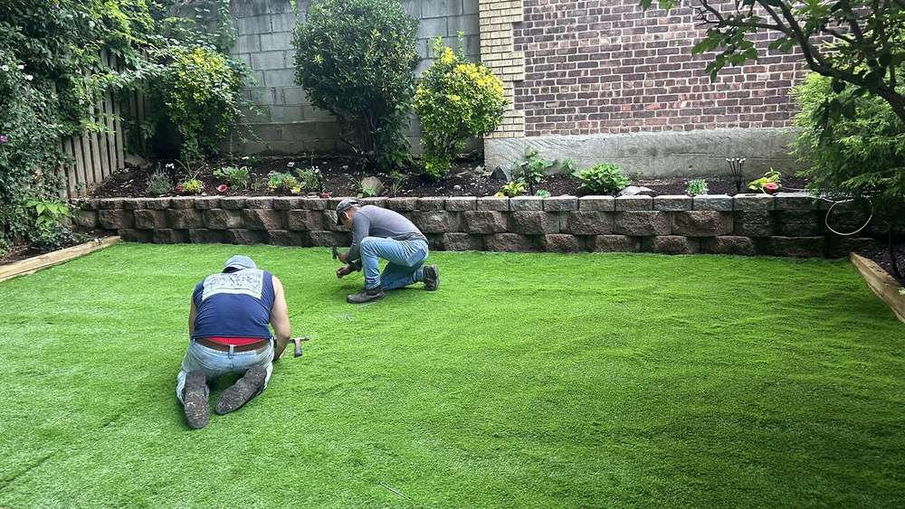 Finished artificial turf lawn installed in the same yard