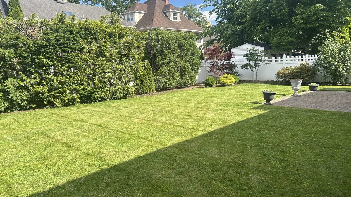 Manicured backyard lawn maintained by GH Landscaping LLC