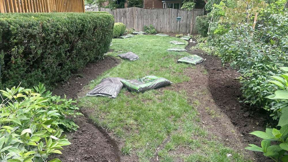 Mulch installation in progress along garden beds